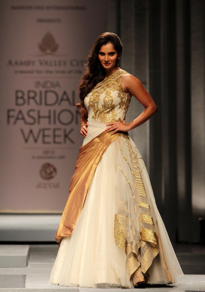 Indian tennis player Sania Mirza walks the ramp displaying an outfit by designers Shantanu and Nikhil during the Aamby Valley India Bridal Fashion Week (IBFW) 2013, in Mumbai on December 2, 2013. (Photo: IANS)