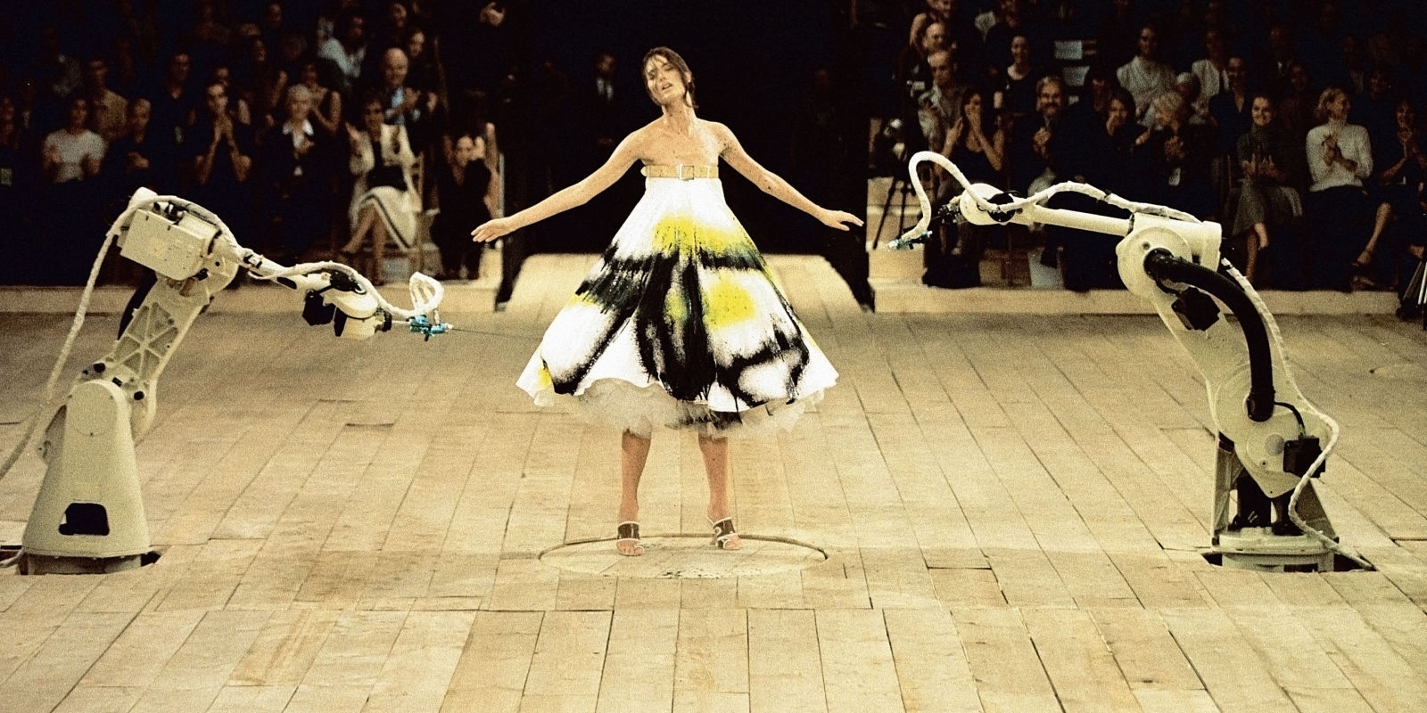 Shalom Harlow presenting the 'Spray painted dress' on the ever theatrical McQueen runway. Circa. S/S '99